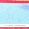 Finished filet crochet cat blanket in light blue showing walking cats design – full view