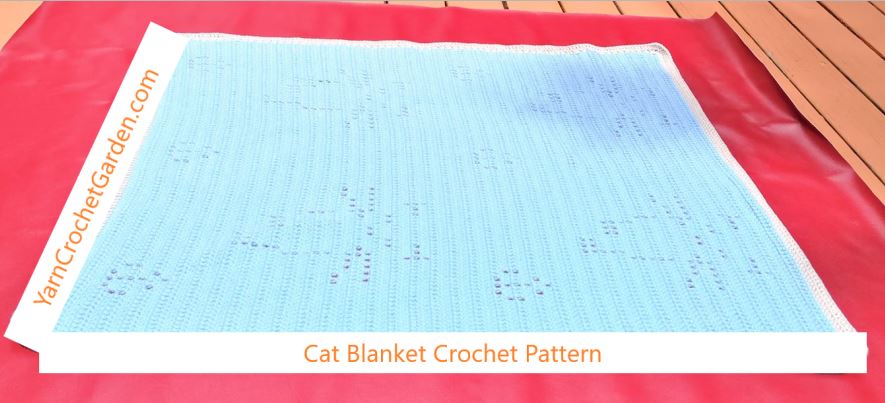 Finished filet crochet cat blanket in light blue showing walking cats design – full view