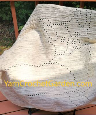 Close-up of filet crochet corgi dog blanket showing double crochet stitch detail