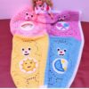 Filet crochet blanket featuring a cute bear with a crescent moon and stars tummy badge — beginner-friendly double crochet pattern sized from baby to adult