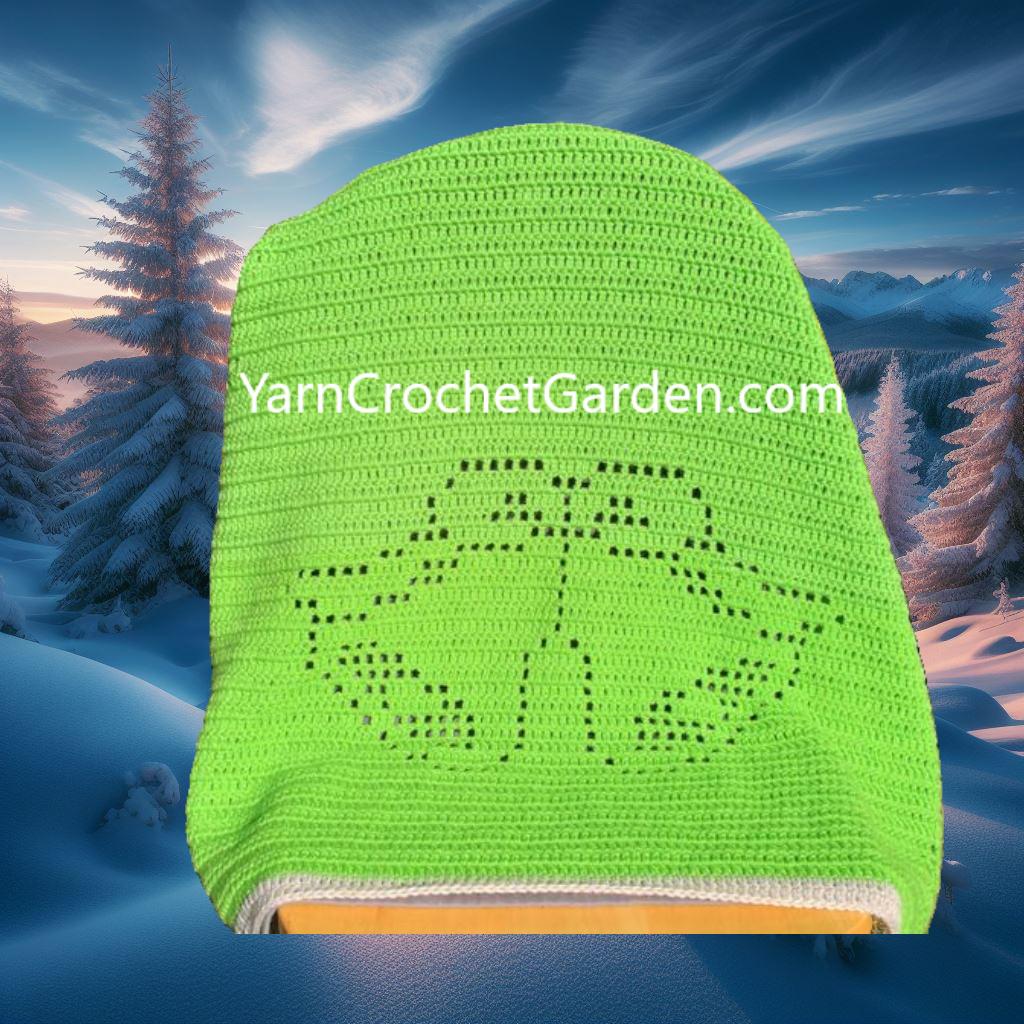 Close-up of a festive Christmas bell and flower pattern on a handmade white filet crochet blanket.