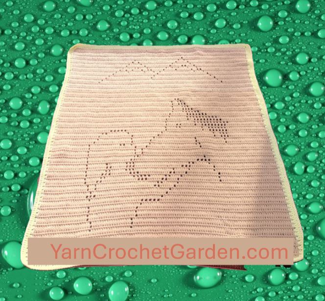 Finished filet crochet blanket featuring a girl patting a horse in a mountain landscape scene, handmade DIY craft project.