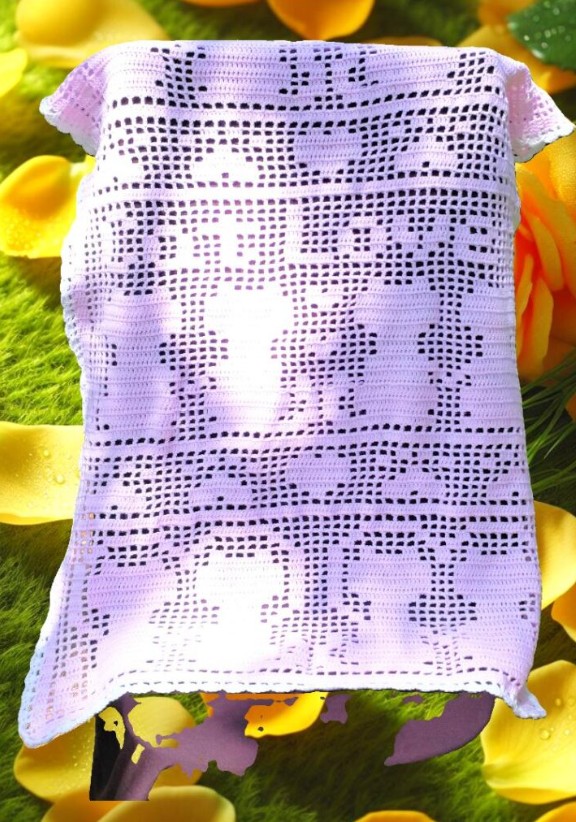 Finished cat filet crochet blanket with heart and paw motifs in a neutral yarn, shown as a living room throw.